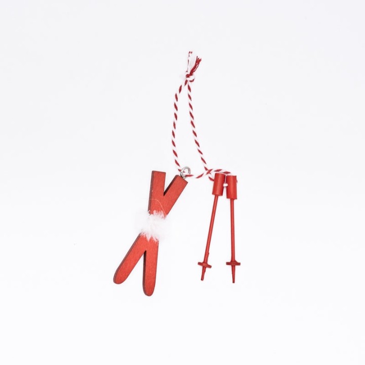Décoratif en bois rouge, forme de ciseaux avec détails blancs et cordon enroulé.