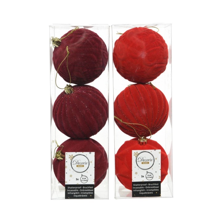 Boules de Noël rouge et bordeaux, texturées, brillantes, élégamment emballées.