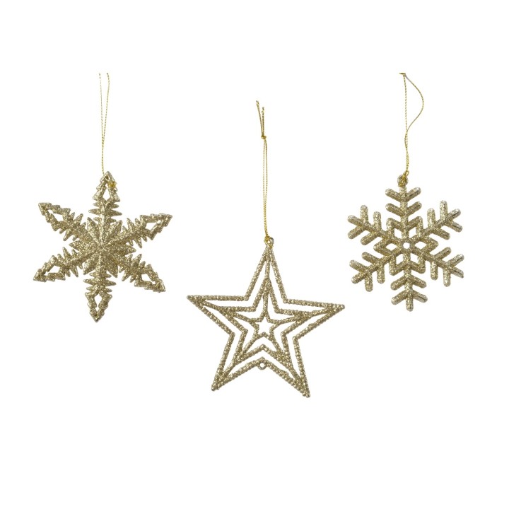 Trois décorations dorées en forme d'étoiles et de flocons de neige scintillants.
