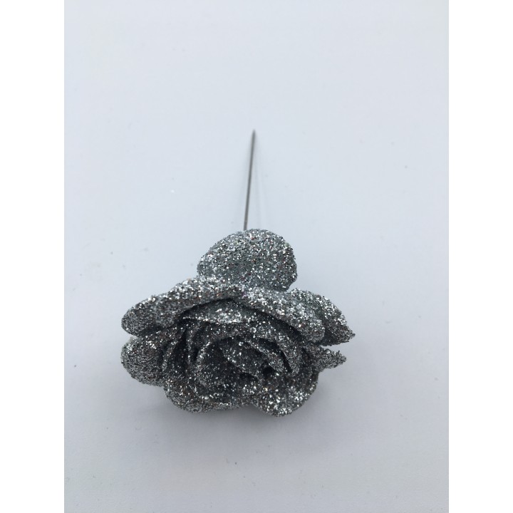 Rose en argent scintillant, pétales brillants et tige fine, sur fond blanc.