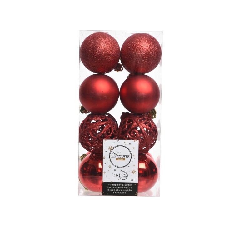 Boules de Noël rouges brillantes et scintillantes dans une boîte transparente.