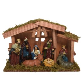 Crèche de Noël en bois avec figures colorées, mousse, et décor traditionnel.