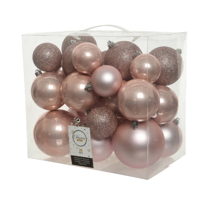 Boules de Noël en rose pâle et doré, brillantes et mates, dans un emballage transparent.
