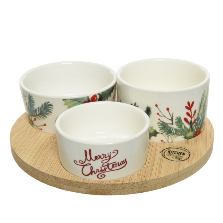 Trois bols en céramique décorés de motifs festifs sur un plateau en bois.