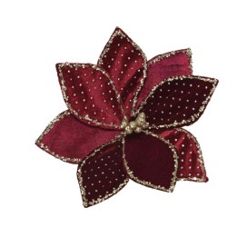 Fleur en velours rouge ornée de perles brillantes, délicate et festive.