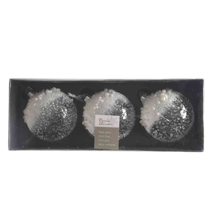Trois boules décoratives blanches et transparentes, scintillantes dans un emballage noir.