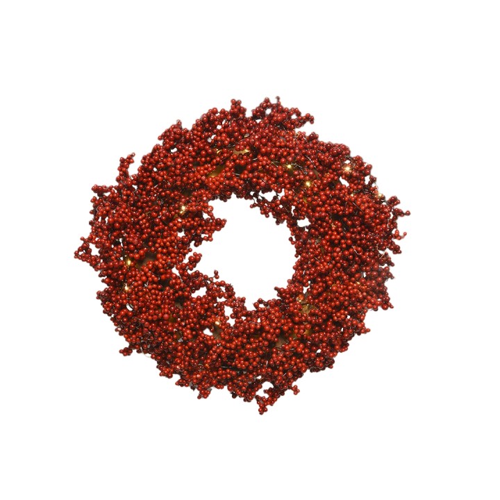 Couronne festive composée de baies rouges sur fond blanc, évoquant la saison hivernale.