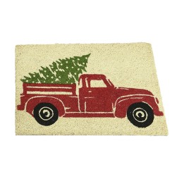 Tapis de bienvenue beige avec un camion rouge transportant un sapin vert.