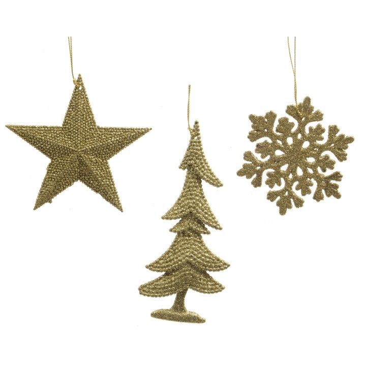 Trois décorations dorées : étoile, sapin et flocon, scintillantes et festives.