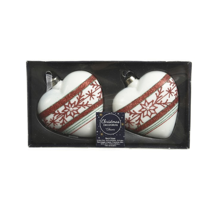 Deux ornements en forme de cœur, blancs avec motifs rouges et bleus, présentés dans une boîte.