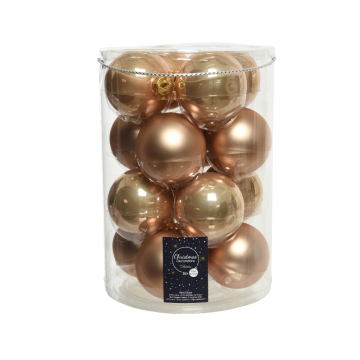 Boules de Noël brillantes et dorées, emballées dans un cylindre transparent.