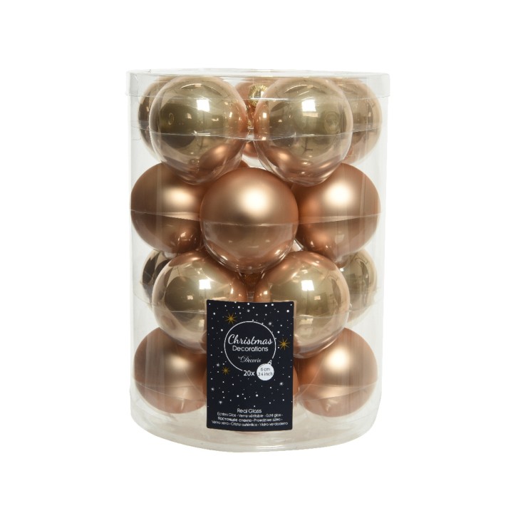 Boules de Noël dorées et cuivrées dans un contenant transparent. Élégance festive.