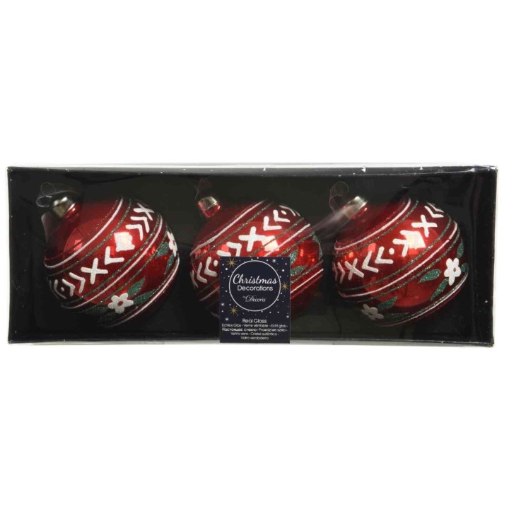 Trois boules de Noël rouges brillantes, décorées de motifs blancs et verts.
