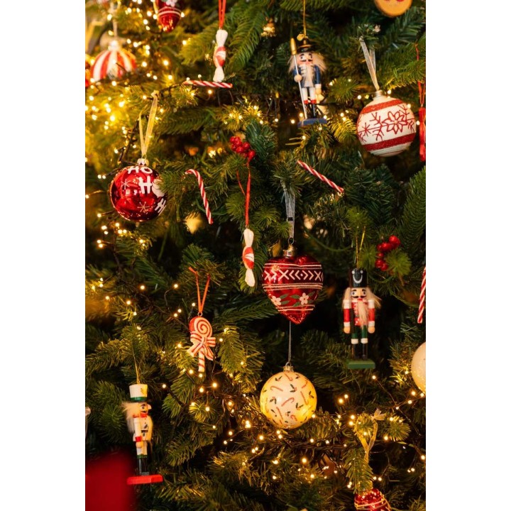 Ornements colorés et lumineux embellissent un sapin, créant une ambiance festive chaleureuse.