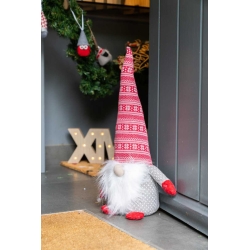 Un nain de Noël en tissu gris, chapeau rouge à motifs, avec une barbe blanche douce.