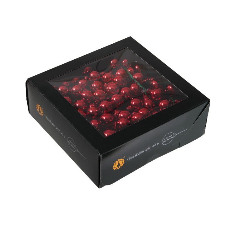 Boîte noire transparente contenant des billes rouges brillantes, élégante et festive.