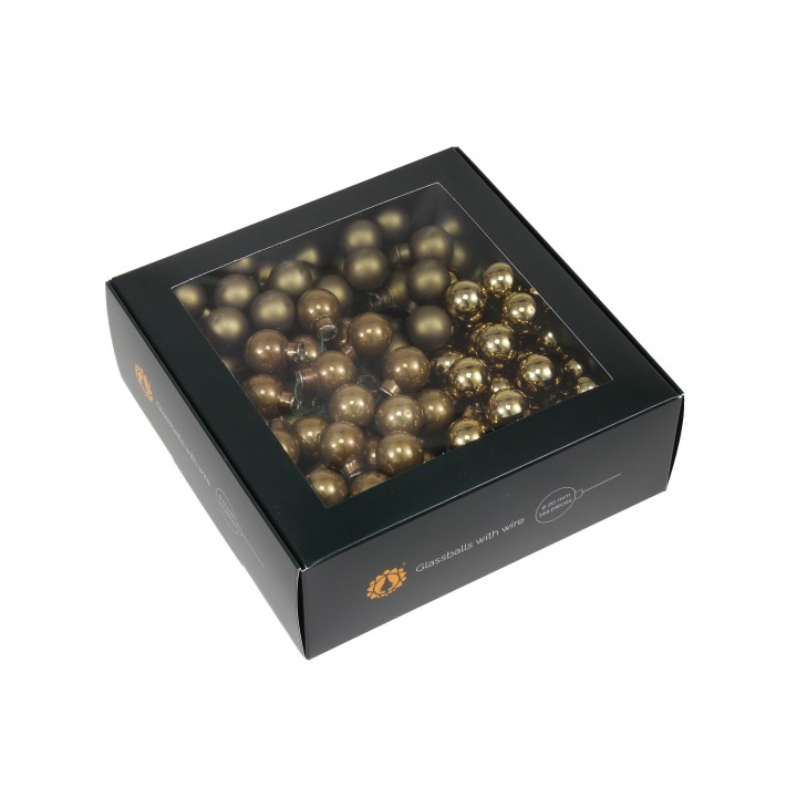 Boîte noire contenant des ornements dorés brillants, ronds et scintillants.