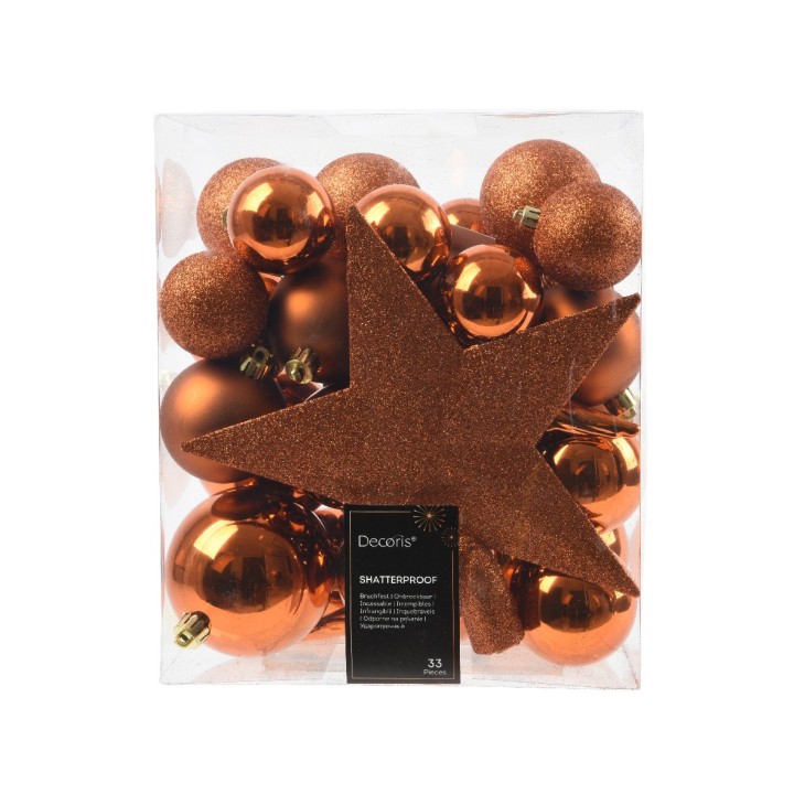 Boules de Noël orange scintillantes et étoile dorée dans un emballage transparent.