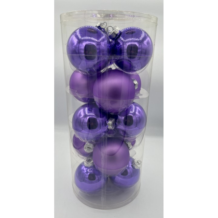 Boules de Noël violettes brillantes, empilées dans un tube transparent.