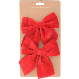 Deux grands nœuds en velours rouge sur une carte kraft, festive et élégante.