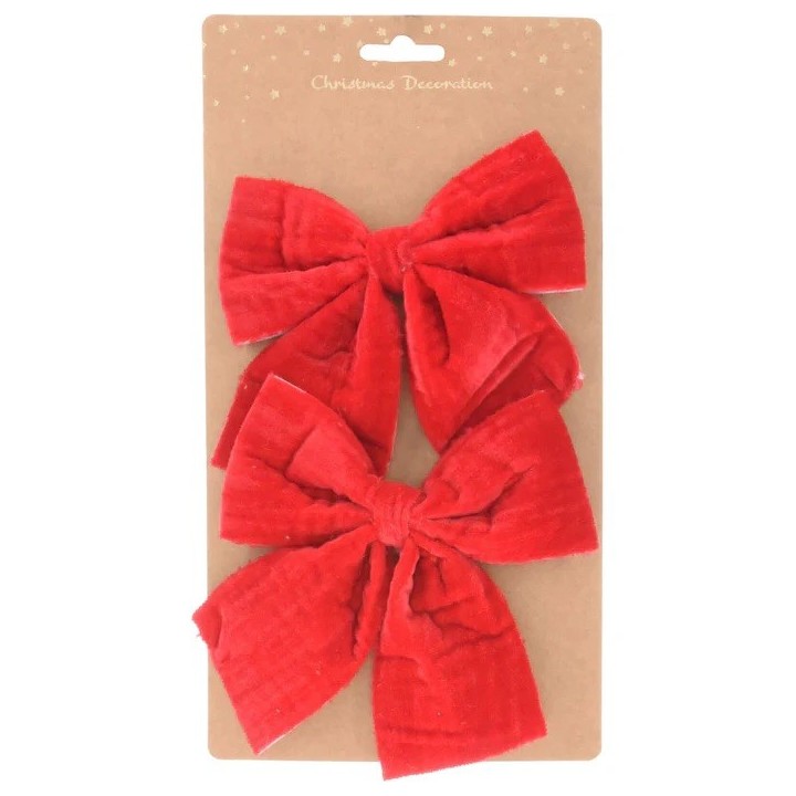 Deux grands nœuds en velours rouge sur une carte kraft, festive et élégante.