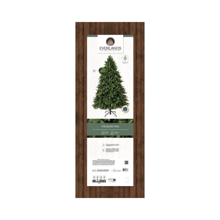 Étiquette de sapin artificiel avec vert foncé et support en métal sur fond bois.