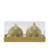 Boules décoratives dorées, texturées, présentées dans un emballage transparent élégant.