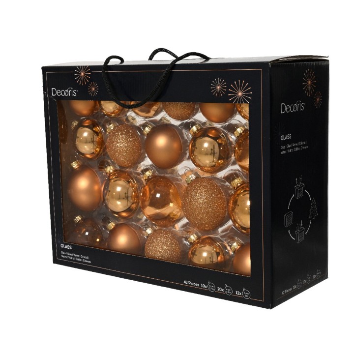 Coffret noir contenant des boules décoratives dorées brillantes et pailletées.