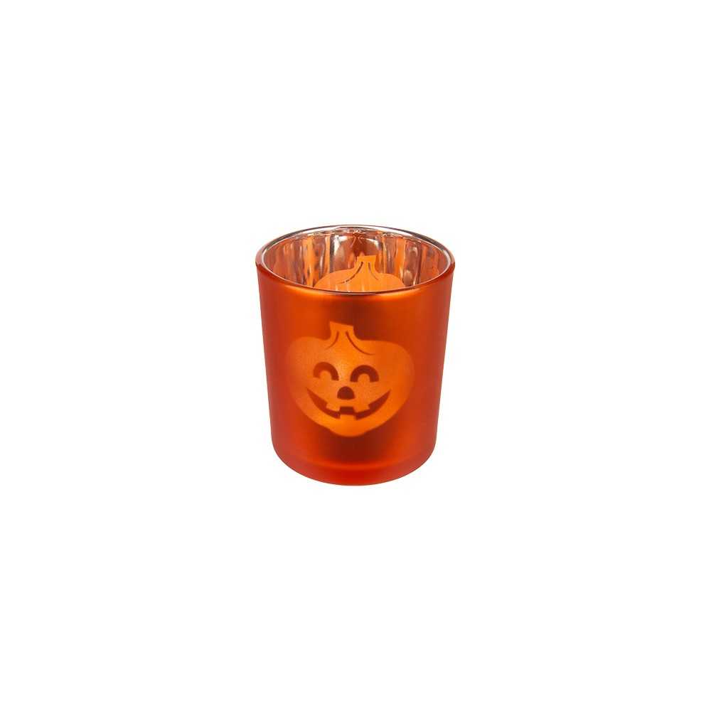 Bougie orange en verre avec un visage de citrouille souriant gravé.