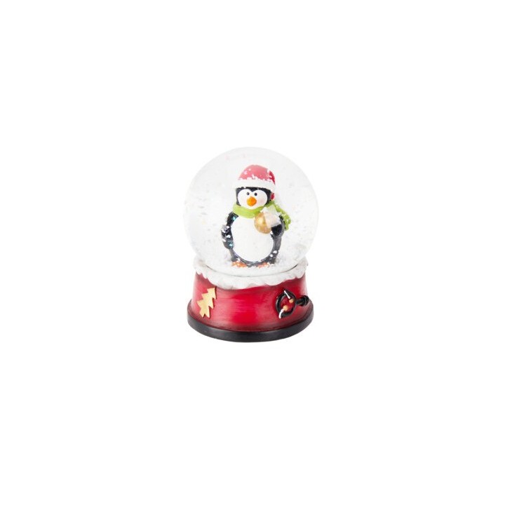 Pinguin en bonnet et écharpe, dans une boule à neige festif sur socle rouge.