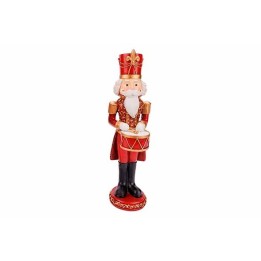 Figurine de soldat en bois, rouge et doré, tenant un tambour, festive et traditionnelle.