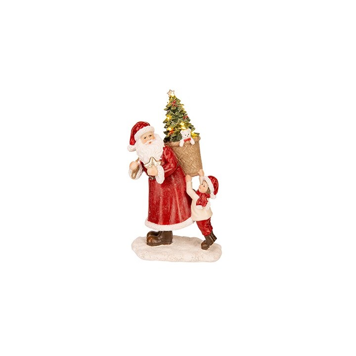 Père Noël en rouge portant un sapin, accompagné d'un enfant joyeux.