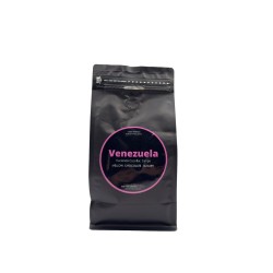 Sac noir élégant avec étiquette colorée indiquant "Venezuela", évoquant un café riche.
