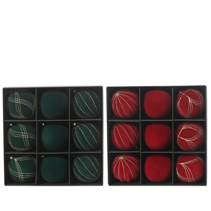 Ornements de Noël verts et rouges, élégamment disposés dans une boîte en noir.