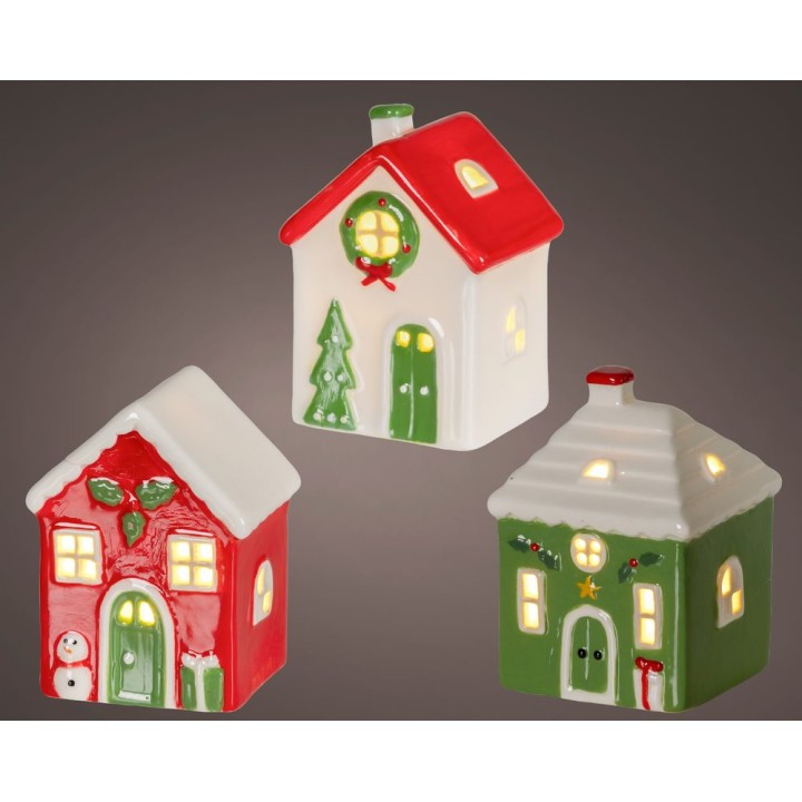 Trois petites maisons en céramique aux couleurs festives, illuminées par de petites fenêtres.