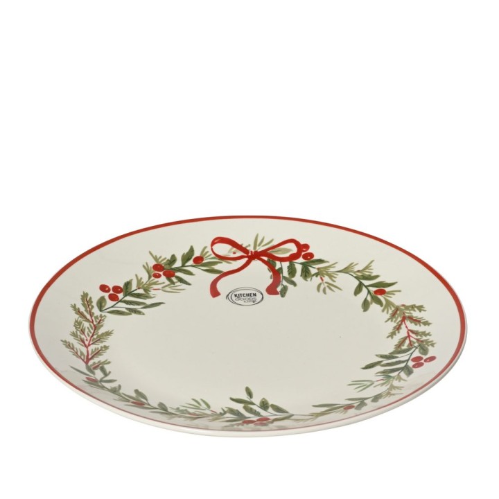 Assiette ovale blanche ornée d'un motif festif de feuillage et d'un nœud rouge.