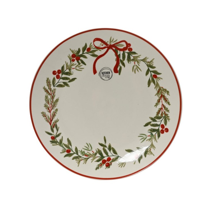 Assiette blanche décorée d'une couronne de feuillage vert et de baies rouges, bord rouge.