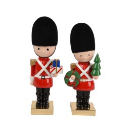 Deux figurines de soldats en uniforme rouge, l'une avec un cadeau, l'autre avec un sapin.