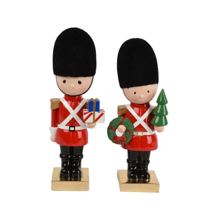 Deux figurines de soldats en uniforme rouge, l'une avec un cadeau, l'autre avec un sapin.
