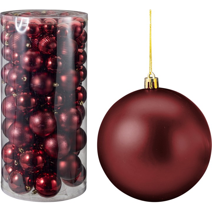 Boules de Noël rouges brillantes dans un tube transparent, une grande boule suspendue.