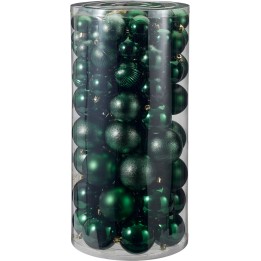 Ornements de Noël verts variés, brillants et mats, présentés dans un cylindre transparent.