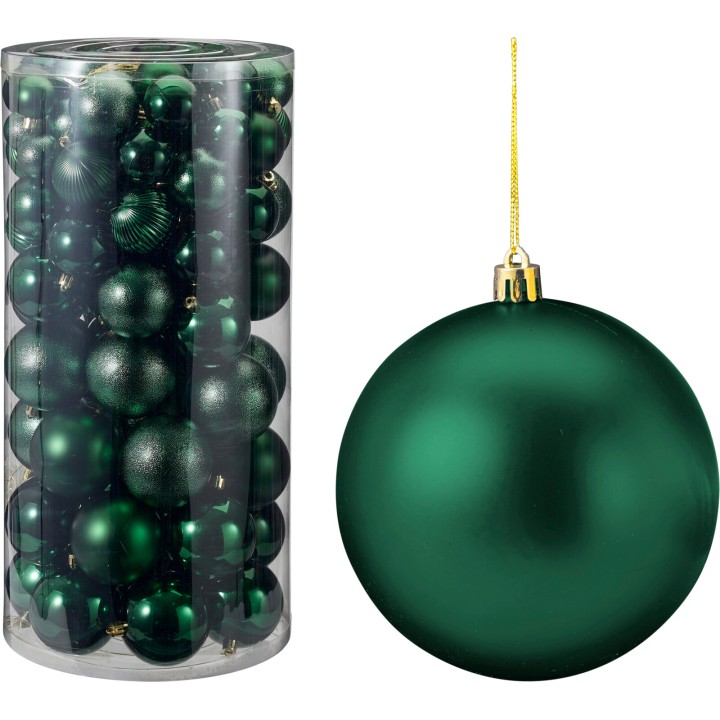 Boules de Noël vert émeraude brillantes, diverses textures, dans un tube transparent.