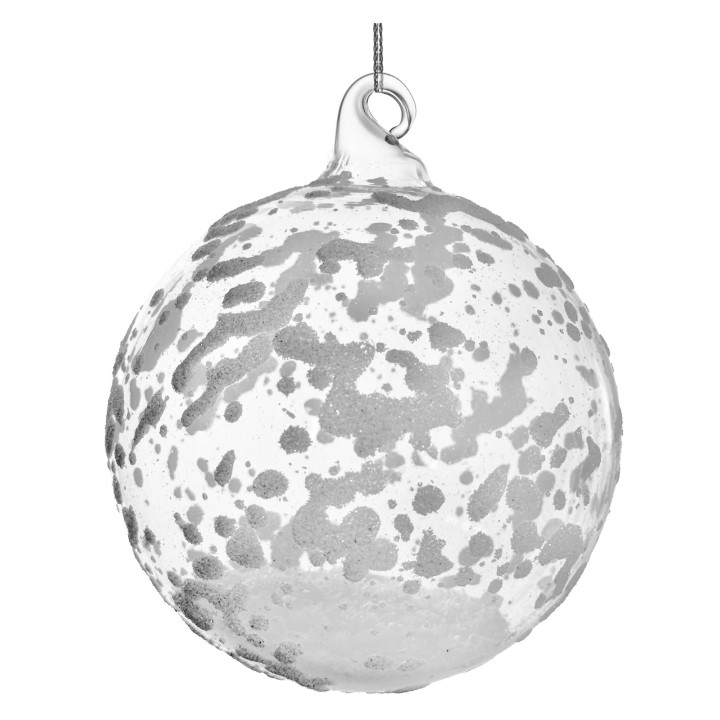 Boule en verre translucide avec motifs argentés, évoquant une planète stylisée.